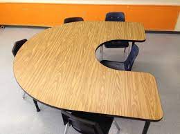 A table in the shape of a 'U' to foster discussion.